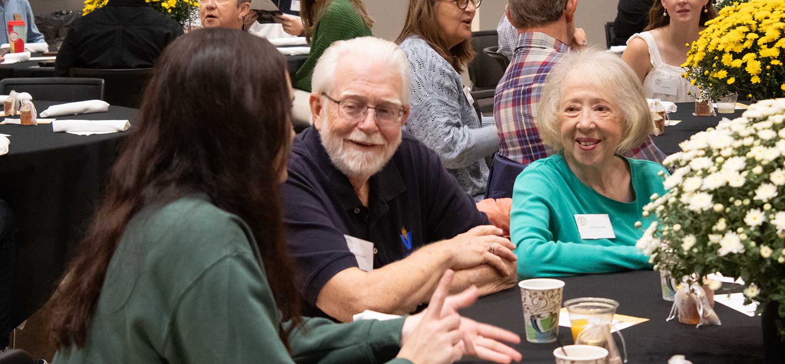 people sitting at a table at an even talking