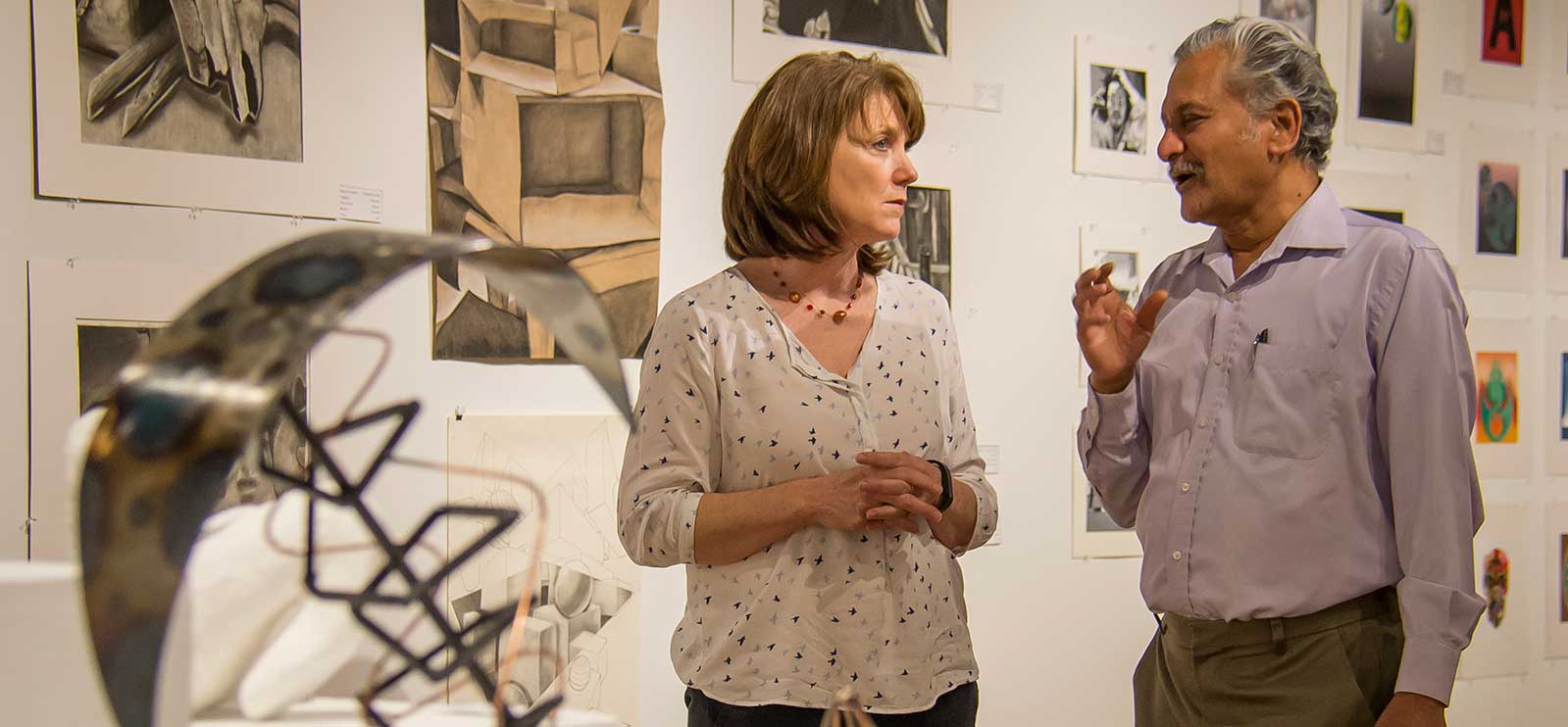 faculty talking in an art gallery